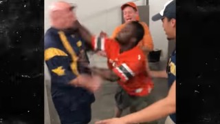 Miami Hurricanes Fan Slugs One-Legged West Virginia Fan in Bathroom Line